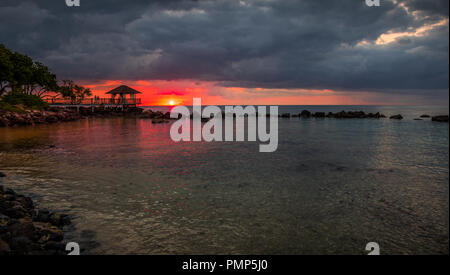 Balaclava, Mauritius - the sun sets over the bay at the Turtle Bay Resort and Spa on the coast of the Indian Ocean island image with copy space Stock Photo