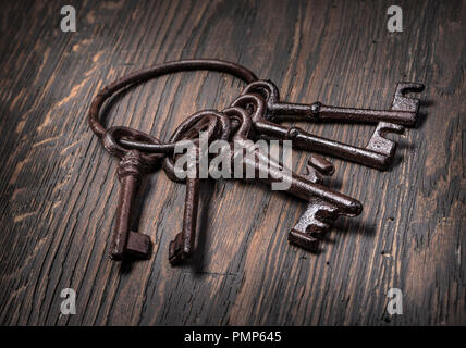 Old rusty keys on wooden  background Stock Photo