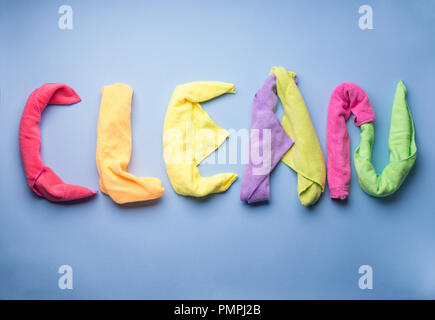 Word Clean written with cleaning cloths as letters on blue pastel background Stock Photo