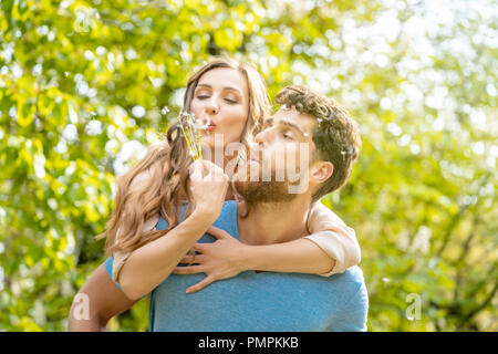 Woman and man on a meadow in romantic mood Stock Photo