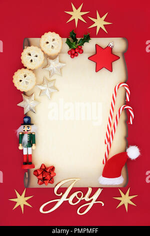 Blank letter to Father Christmas or party invitation with joy sign, mince pies, holly, decorations, candy canes and nutcracker soldier. Stock Photo