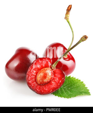three dark red cherries with bright green leaf isolated on white background Stock Photo