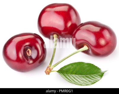 three dark red cherries with bright green leaf isolated on white background Stock Photo