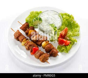 Meat and vegetables grilled on fire isolated on white Stock Photo