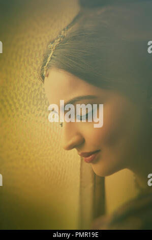 Side view of a beautiful Indian woman by the window eyes closed Stock Photo