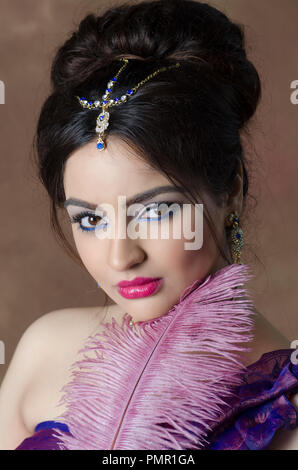 Beautiful Indian woman holding a feather Stock Photo