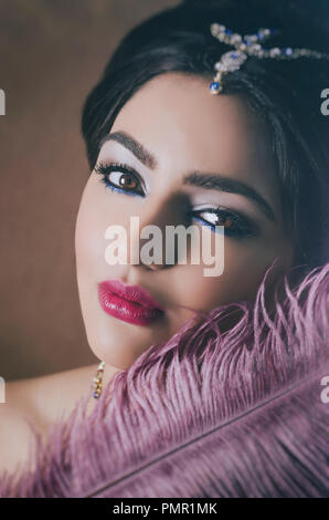 Close up portrait of a beautiful Asian woman feather touching face Stock Photo