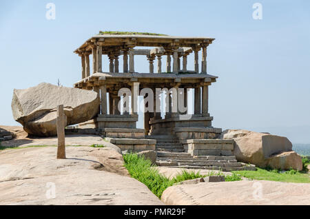 Beautiful ancient architecture of a two-storey granite pavilion on Hemakuta Hill in Hampi, Karnataka, India