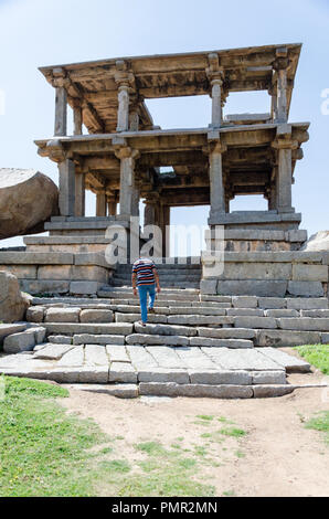 Beautiful ancient architecture of a two-storey granite pavilion on Hemakuta Hill in Hampi, Karnataka, India