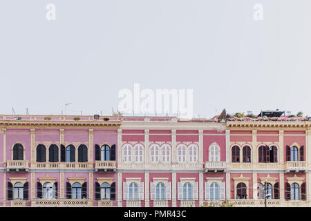 A row of pretty pastel facades / buildings on the sea front near the port in Calgliari, Sardinia Stock Photo