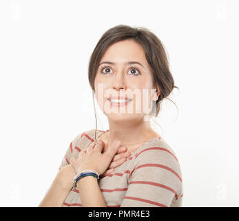 Joyful woman holding hands on chest Stock Photo
