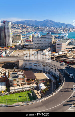 Genova, Italy - January 17, 2018: Genova city round overpass and modern buildings, industrial port district. Vertical photo Stock Photo