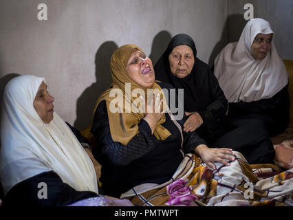 Gaza City, The Gaza Strip, Palestine. 19th Sep, 2018. Relatives of Palestinian Ahmed Omar, who was killed during a protest near the Israeli Erez crossing with Gaza, mourn during his funeral in Al-Shati refugee camp in Gaza City. Credit: Mahmoud Issa/SOPA Images/ZUMA Wire/Alamy Live News Stock Photo