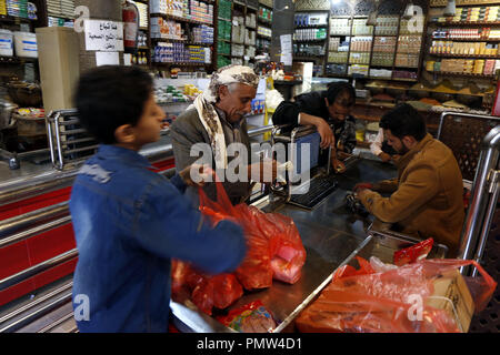 Sanaa, Yemen. 19th Sep, 2018. A Yemeni man shops at a supermarket in Sanaa, Yemen, on Sept. 19, 2018. In the historical old city of Yemen's capital Sanaa, people here are suffering badly from war and air-sea-land blockade that has been devastating lives of more than 25 million population for over three years. Credit: Mohammed Mohammed/Xinhua/Alamy Live News Stock Photo