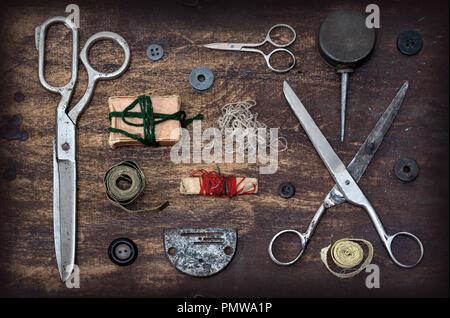 Old Sewing accessories on wooden table Stock Photo