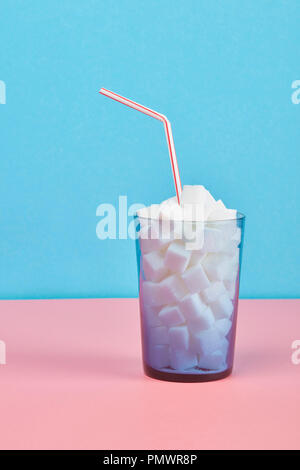 Glass filled with sugar cubes and straw Stock Photo