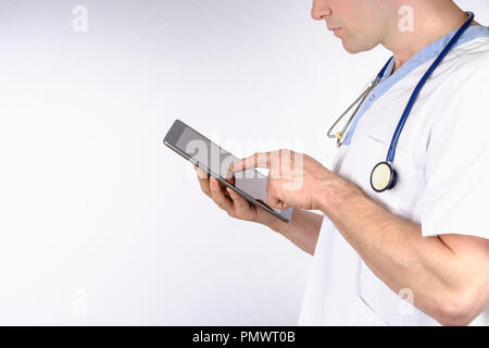 Doctor using digital tablet against white background Stock Photo