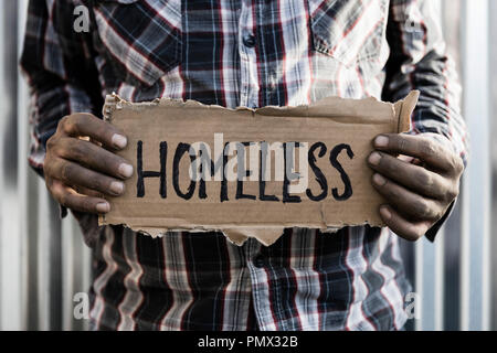 Homeless man holding sign Stock Photo