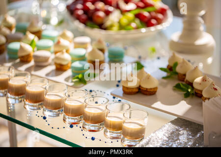 Creamy coffee liqueur with caramel on a table. glasses with bailis at a wedding reception Stock Photo