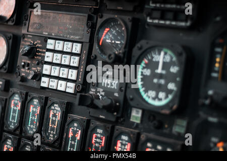 Control dashboard and panel inside an aircrafts's cockpit, details of pressure, speed, altitude and emergency indicators. War concept. Stock Photo