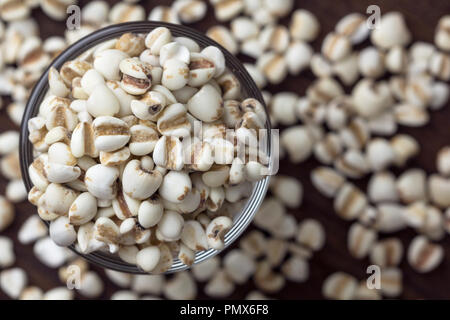 Millet grain in glass cups on wooden close up.	 Stock Photo