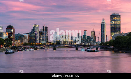 London, England, UK - September 10, 2018: The sun sets behind the River Thames and Lambeth Bridge, with the modern riverside skyline of office blocks, Stock Photo