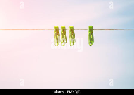 Clothespins on a rope against the sky Stock Photo