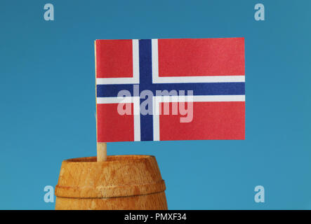 A national flag of Norway on wooden stick in wooden barrel. Blue background Stock Photo