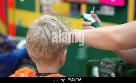 haircut of a little boy in a children's hairdressing salon Stock Photo