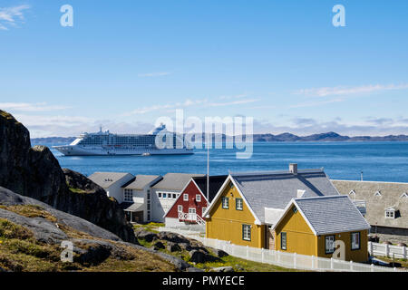 Ocean cruise liner Seven Seas Voyager moored offshore in Nuup Kangerlua fjord beyond Greenland National Museum in old town.  Nuuk Sermersooq Greenland Stock Photo