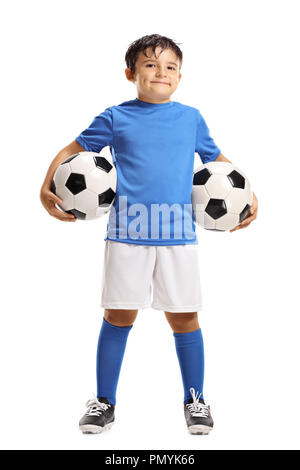 Full length portrait of a young boy holding two soccer balls isolated on white background Stock Photo