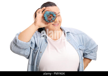 Overweight woman peeking through a chocolate donut isolated on white background Stock Photo