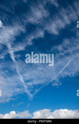 Wispy Cirrus cloud formations against a deep blue sky. Stock Photo