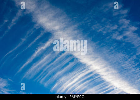 Wispy Cirrus cloud formations against a deep blue sky. Stock Photo