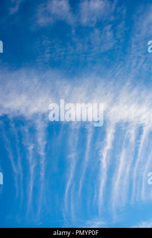 Wispy Cirrus cloud formations against a deep blue sky. Stock Photo