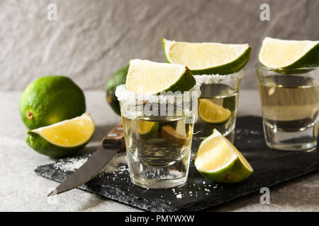 Mexican Gold tequila with lime and salt on gray background Stock Photo