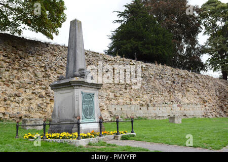 Boer War memorial surrounded by flowers, outside the Norman castle wall in Tonbridge, Kent, England Stock Photo