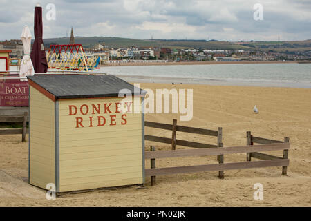A sign advertising donkey rides in Weymouth Dorset England UK GB Stock Photo