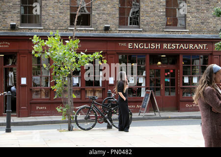 People and bikes outside The English Restaurant on Brushfield Street in Spitalfields East London England UK  KATHY DEWITT Stock Photo