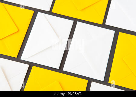 Composition with white and yellow, envelopes on the table. Different colored envelopes on the table. Stock Photo