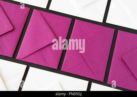 Composition with white and purple envelopes on the table. Different colored envelopes on the table. Stock Photo