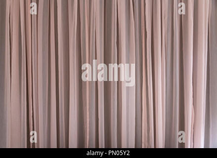 Soft pink-coloured curtains with gentle folds. Would be great as a background image. Stock Photo