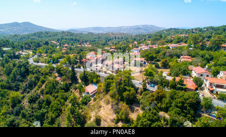 Aerial view of Pano Platres village,winter resort, on Troodos mountains, Limassol, Cyprus. Bird's eye view of pine tree forest, red roof tiled houses, Stock Photo