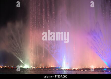 multi-coloured jets of water fountain illuminated lights Stock Photo