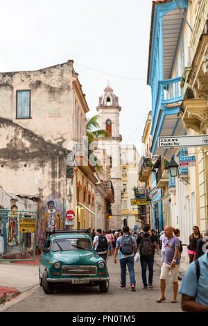 City street scene with green classic car, Havana, Cuba Stock Photo