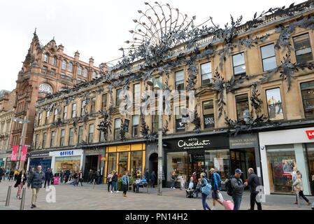 The peacock feather metal artwork adorning the Princes Square building on Buchanan Street with people walking past in Glasgow, Scotland, UK Stock Photo