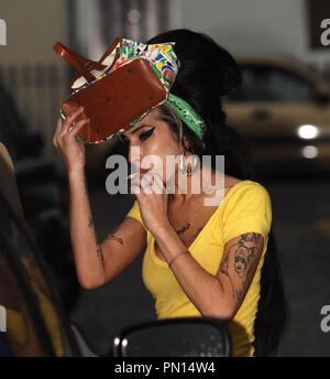 London. Singer Amy Winehouse leaves her London home on the way to a photoshoot at trendy Hoxton studio . Husband Blake Fielder-Civil carried some of Amy's designer 'Betsey Johnson' shoes to her car before Amy said her goodbyes and headed off to the studio with a stop off at McDonalds.   After a meal the 24 year old, who is rumoured to have an eating disorder, left with a drink and  arrived at th e studio carrying the shoe boxes one of which was marked with the description ' Polka Dot Woven Leather Platform Heel'.   2 October 2007 Ref: LMK84-1887-021007    McGarry/Landmark/MediaPunch Stock Photo