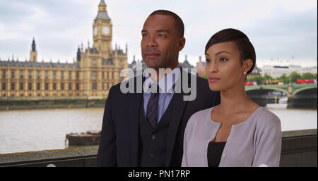 Two proud African-American professionals looking off into distance in London Stock Photo