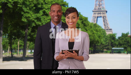 Smiling African-American business professionals with confidence near Eiffel Tower Stock Photo