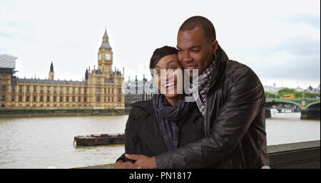 Happy ethnic couple enjoy themselves in London with Big Ben in background Stock Photo